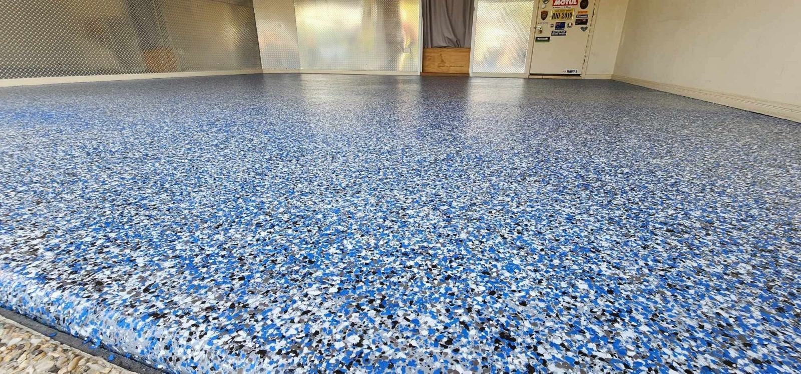 Blue decorative flake flooring completed by PrimeShield Epoxy